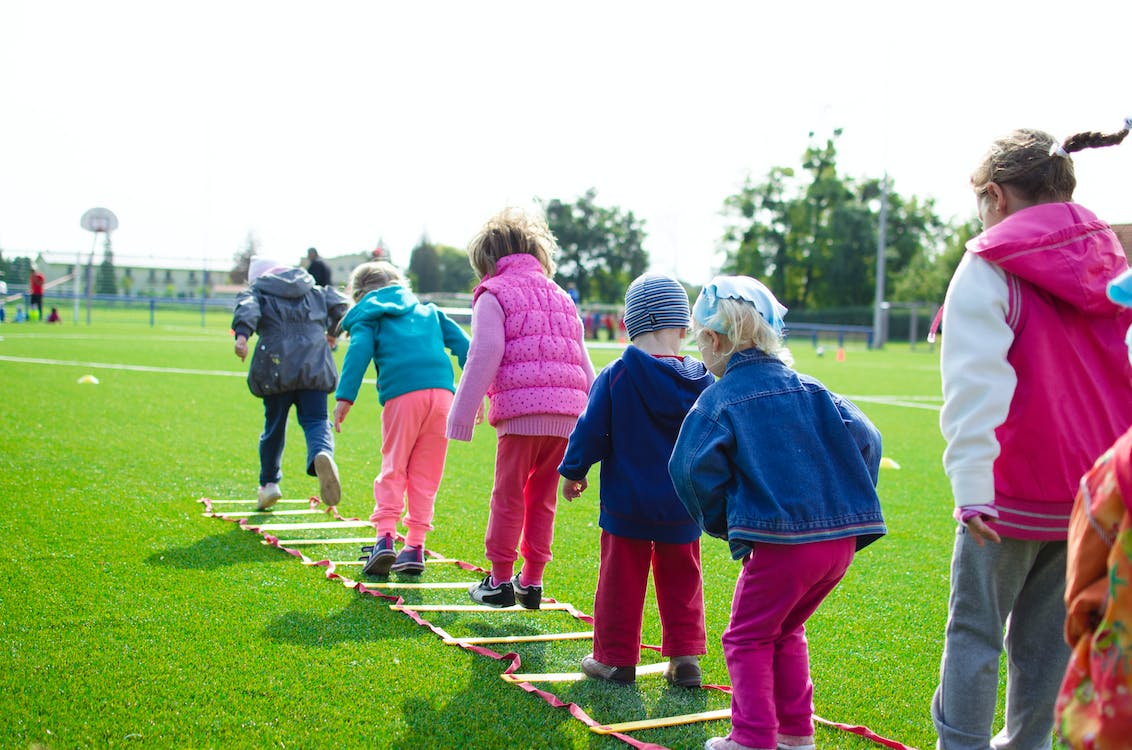 Group of children engaged in play and forming a line