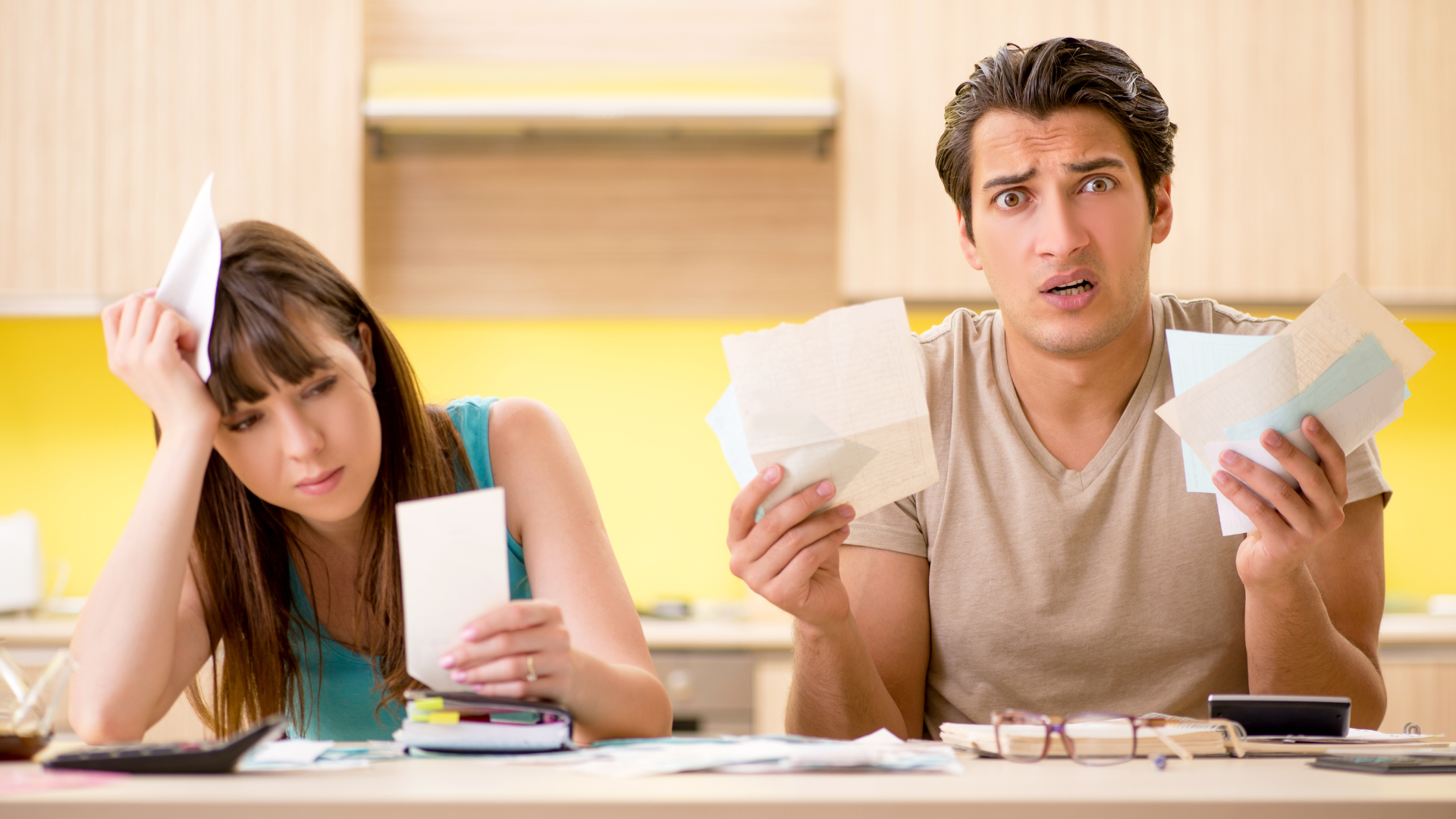 Couple holding documents looking worried