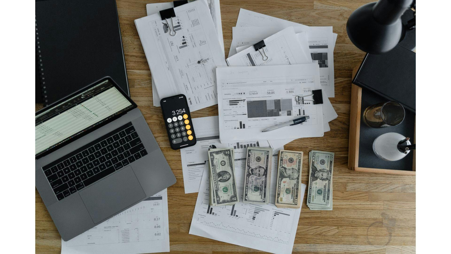 Cash, laptop, cellphone and other documents in the table